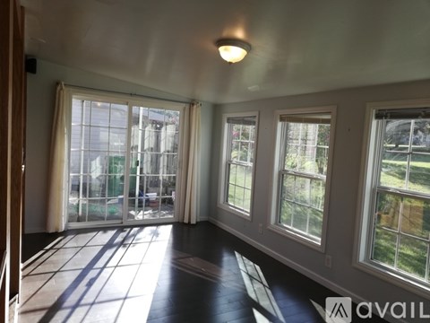 A room with a large window and a sliding glass door.