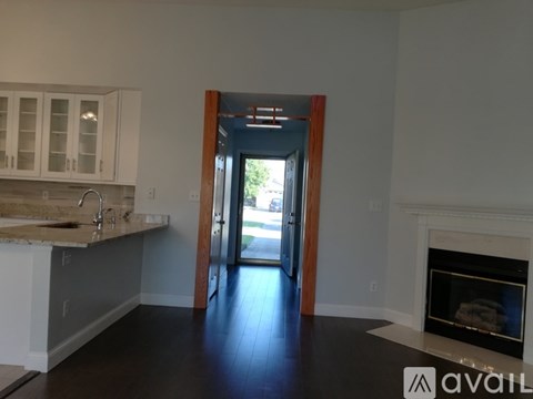 A kitchen with white cabinets and a marble countertop.