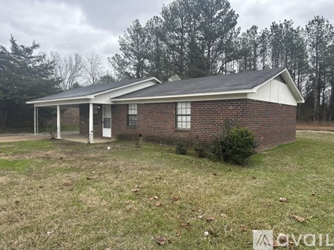 A small brick house with a white door and windows.