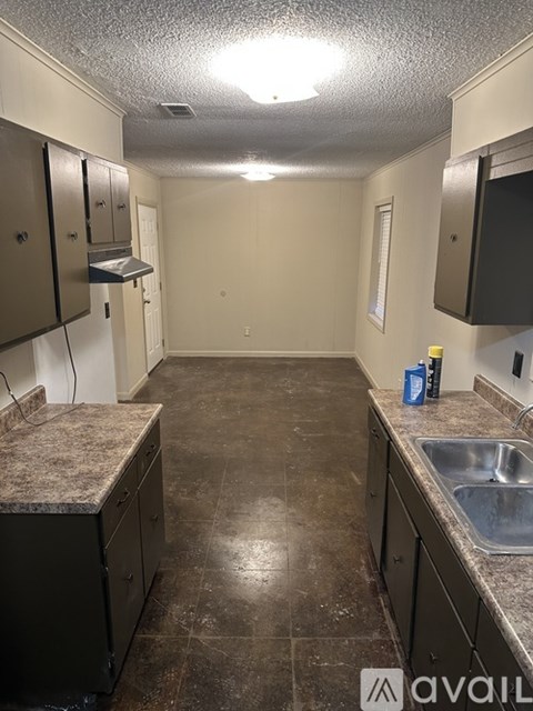 A kitchen with brown cabinets and a sink.