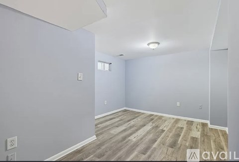 A room with light grey walls and wooden flooring.