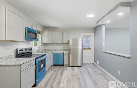 A kitchen with a blue oven and a white fridge.