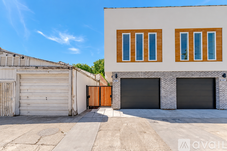 A two-story building with a garage door and windows.