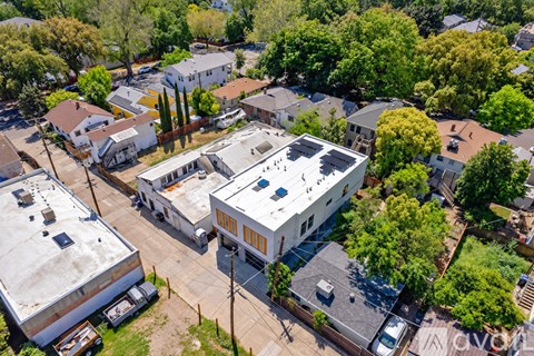 A bird's eye view of a residential area with houses and trees.