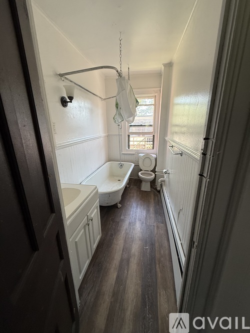 A bathroom with a toilet, sink, and bathtub.