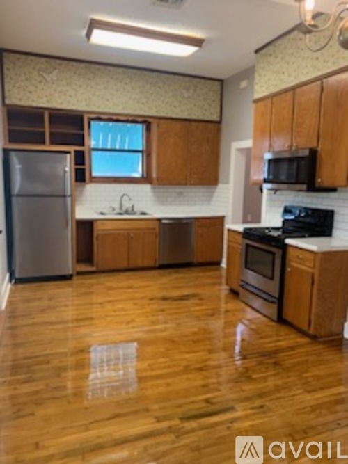 A kitchen with wooden cabinets and a black stove top oven.