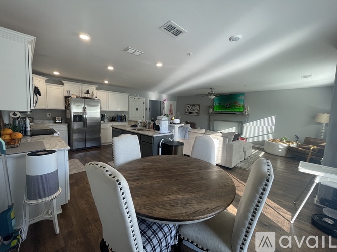 A kitchen with a table and chairs in the foreground.