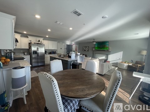 A kitchen with a table and chairs in the foreground.
