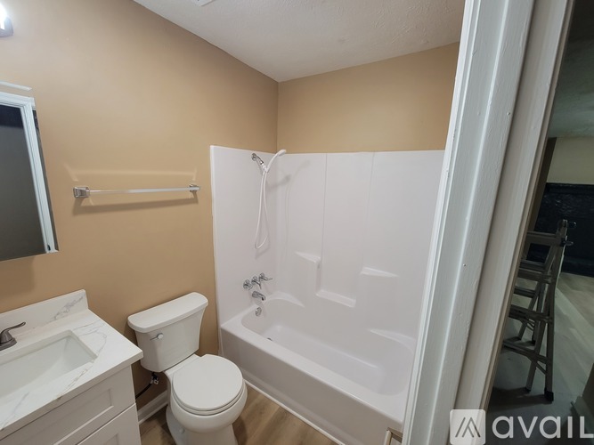 A bathroom with a toilet, sink, and bathtub.