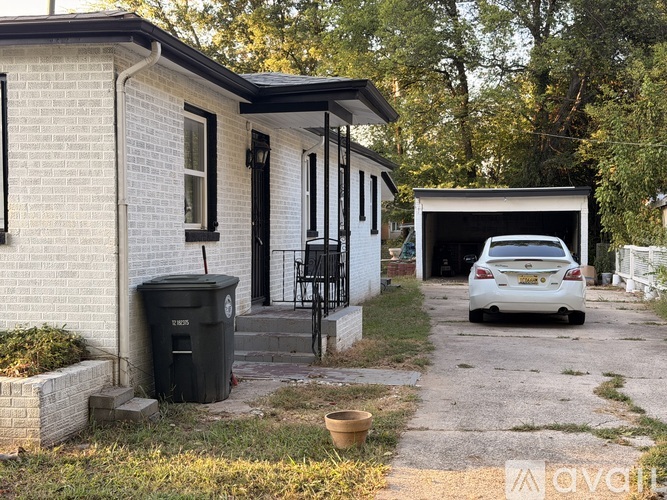 A white house with a car in the driveway.