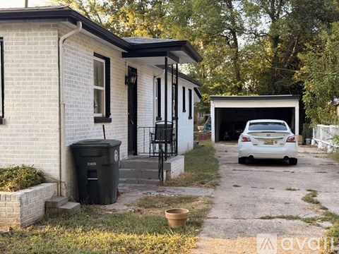 A white house with a car in the driveway.