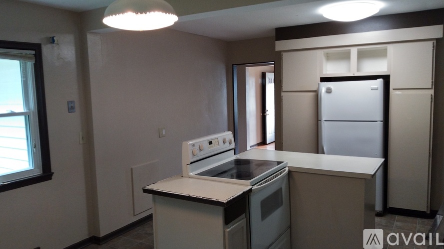 A kitchen with a white oven and black countertops.