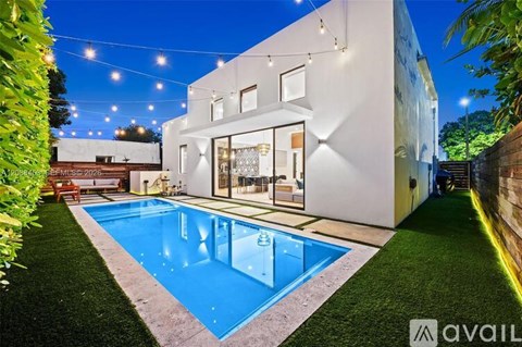 A modern house with a pool in the backyard.