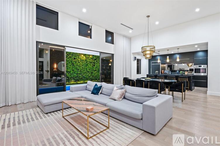 A modern living room with a white sofa and a glass coffee table.