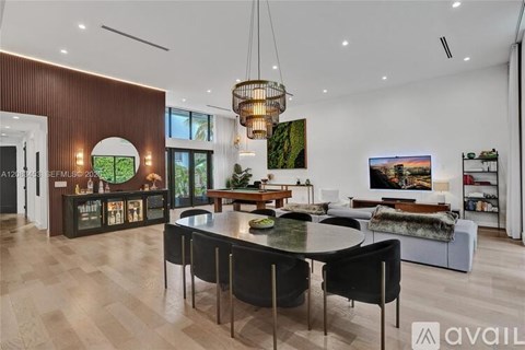 A modern dining room with a large table and chairs.