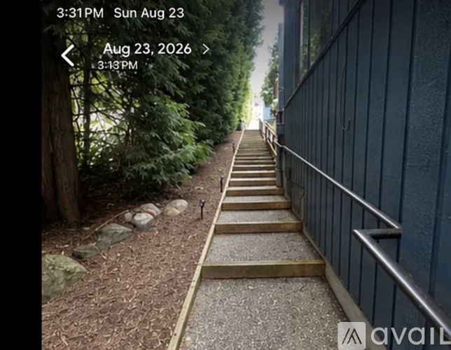 A set of stairs leading up to a building with a railing on the right side.