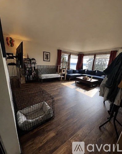 A living room with a grey sofa and a dog bed.