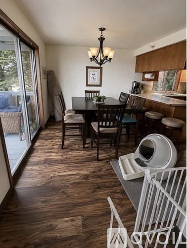 A dining room with a table set for four.
