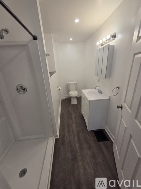 A bathroom with a walk in shower and a toilet.
