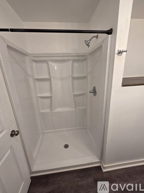 A white bathroom with a walk in shower.