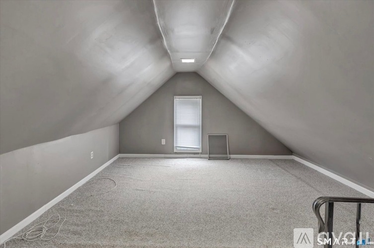 A spacious room with a door and a window.