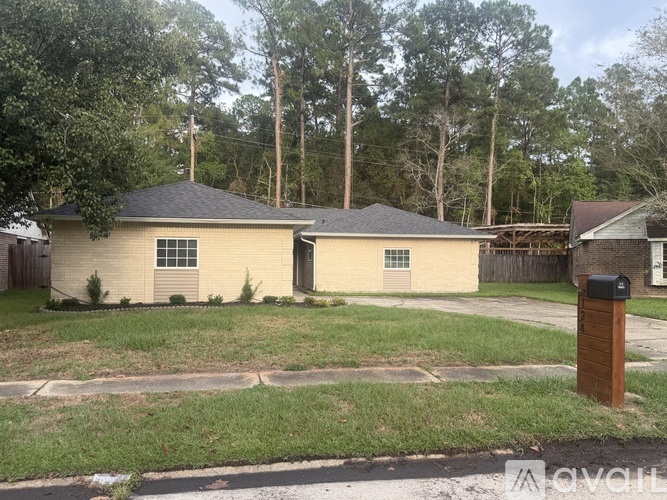 A house with a brown roof and a mailbox in front.