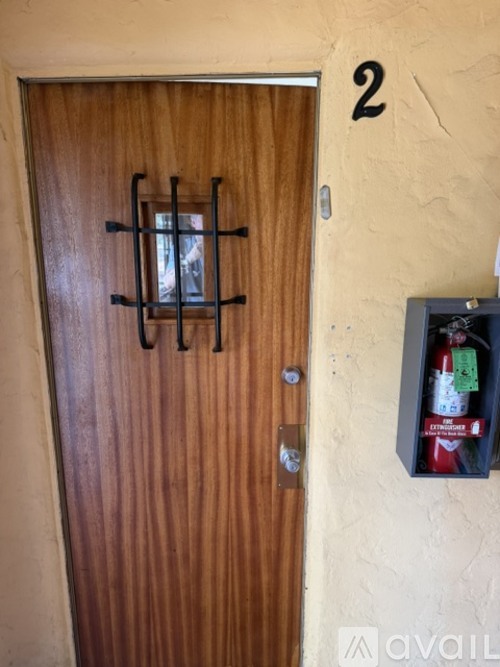 A brown door with a number 2 on the wall above it.