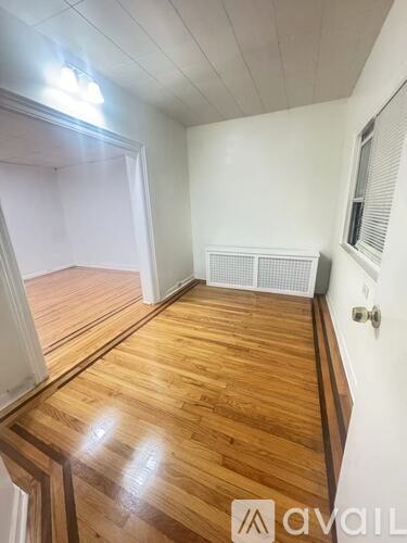 A room with wooden floors and white walls.