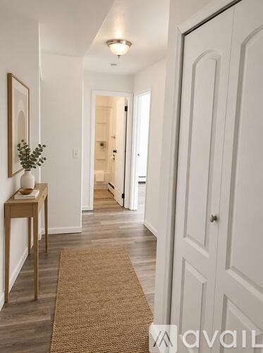 A bedroom with a large bed, a dresser, and a wardrobe.