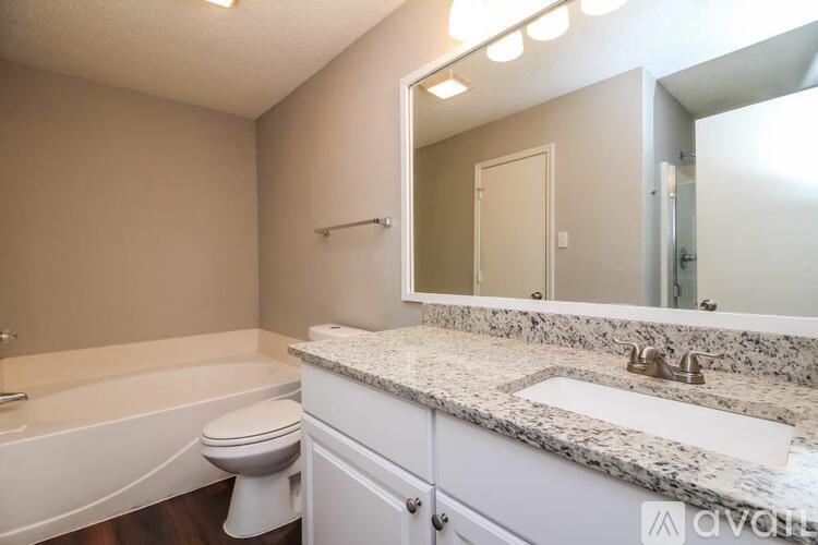 A bathroom with a marble countertop and a white toilet.
