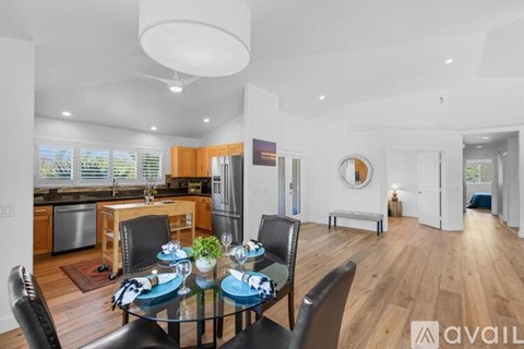 A modern kitchen with a dining table set for four.