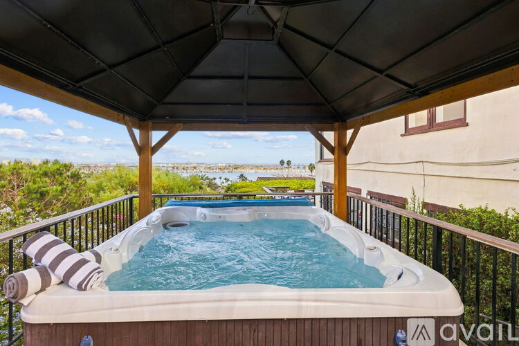 A hot tub on a balcony with a view of the outdoors.