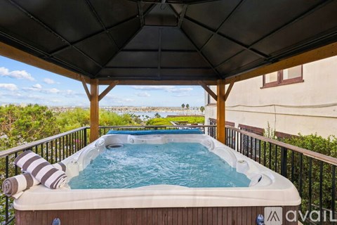 A hot tub on a balcony with a view of the outdoors.