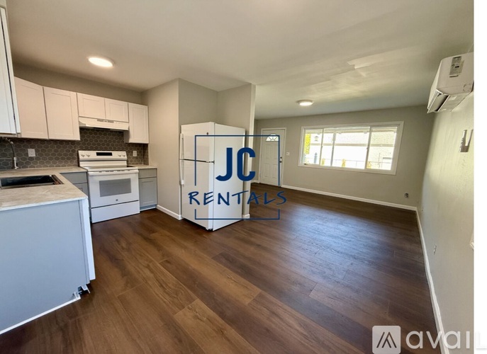 A kitchen area with a sign that says "JC RENTALS" in the middle.