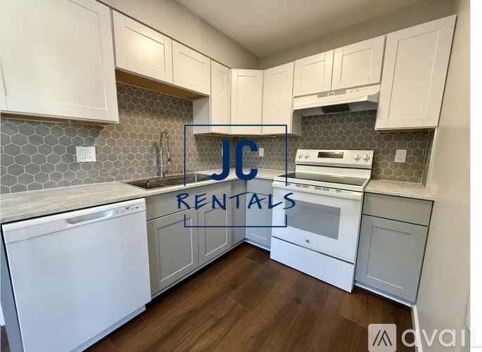 A kitchen with the words "JC RENTALS" written on the wall.