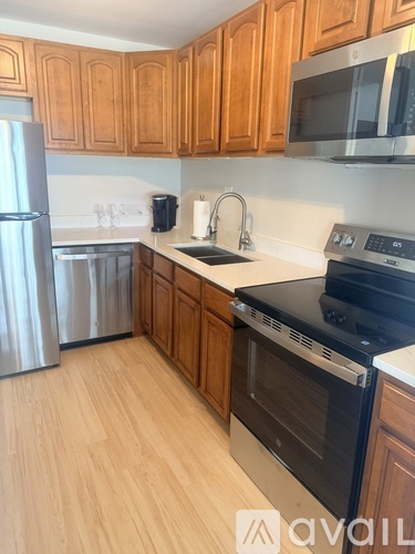 A kitchen with wooden cabinets and stainless steel appliances.