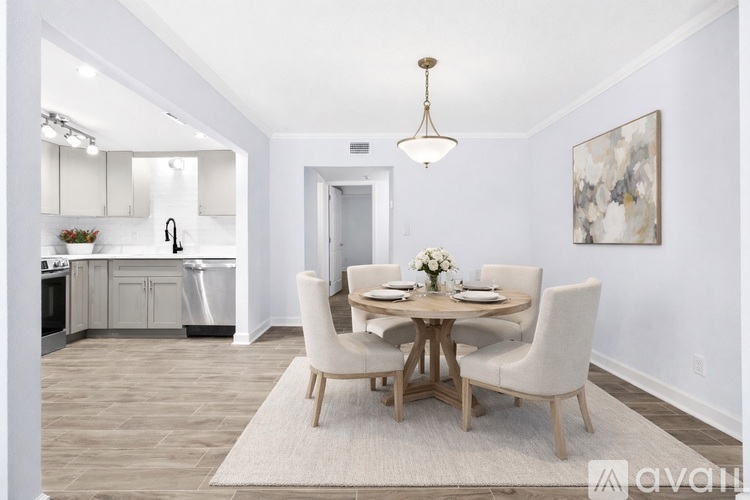 A dining room with a round table and chairs.