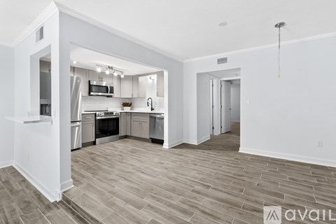 A kitchen with a dining table and chairs is available for rent.