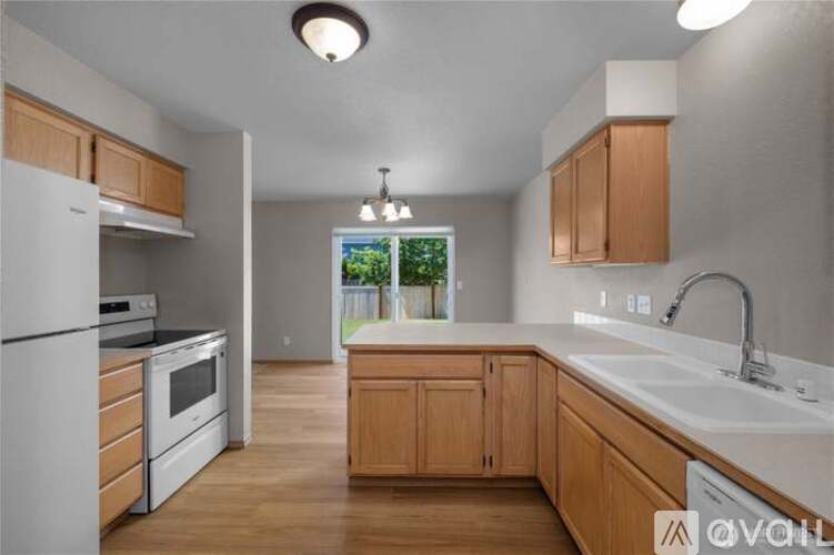 A kitchen with wooden cabinets and a white countertop.