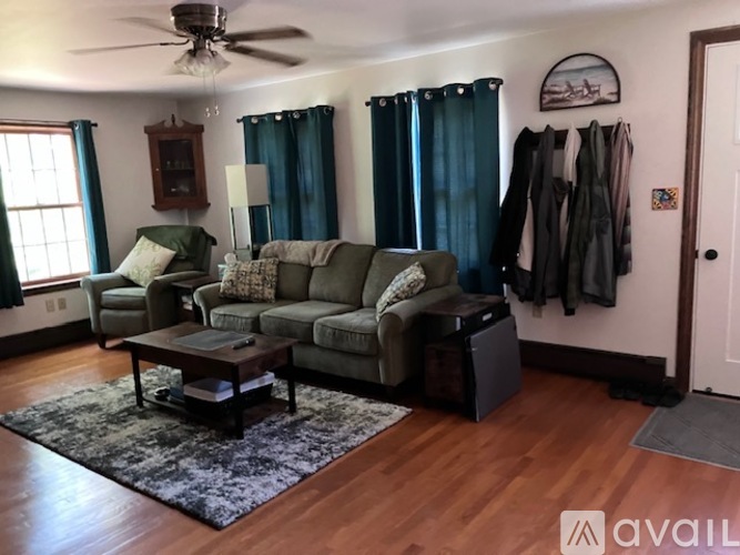 A living room with a grey sofa and a coffee table.