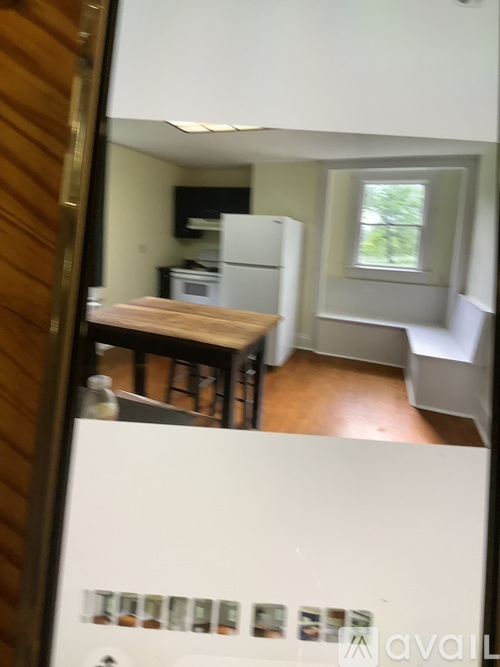 A kitchen with a white fridge and a window.