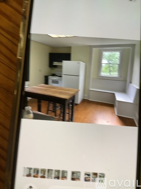 A kitchen with a white fridge and a window.