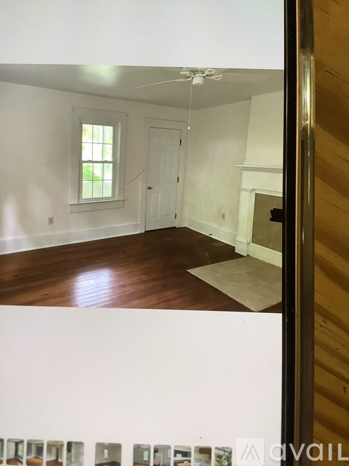 A room with a white wall and a window.