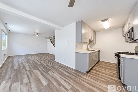 A kitchen area with a counter and cabinets.