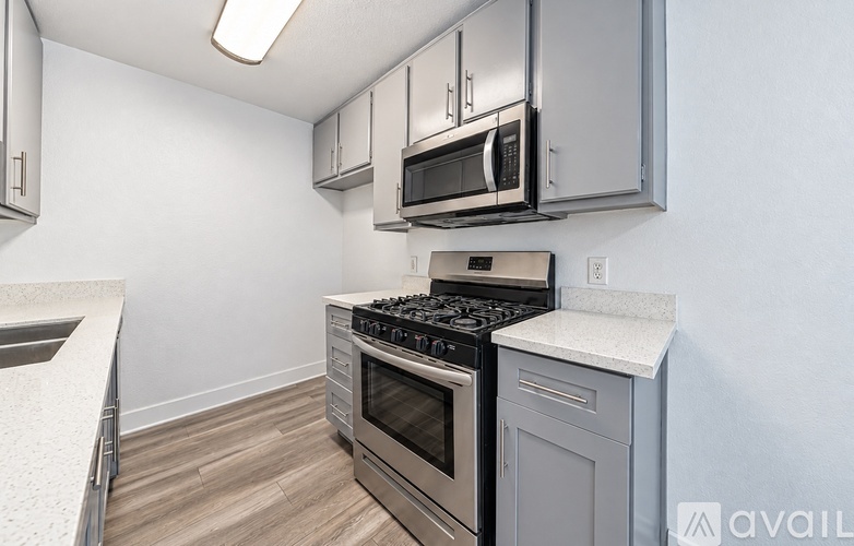 A kitchen with a stove top oven and microwave above it.