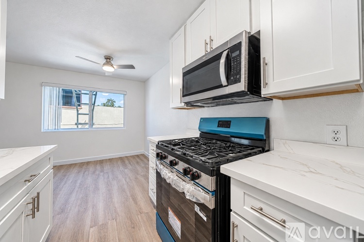 A kitchen with a stove top oven and microwave above it.