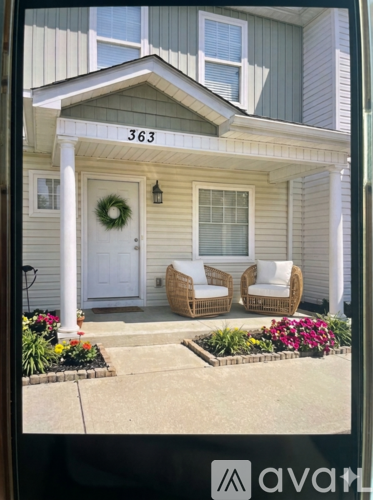 A house numbered 363 has a wreath on the door and a sign that says "welcome".