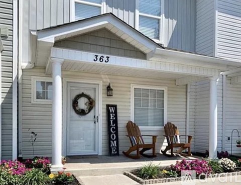 A house numbered 363 has a wreath on the door and a sign that says "welcome".