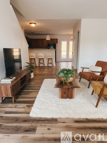 A living room with wooden floors and furniture.