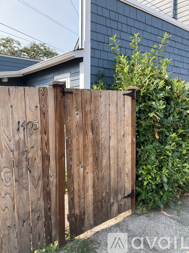 A wooden gate with the number 1405 on it.